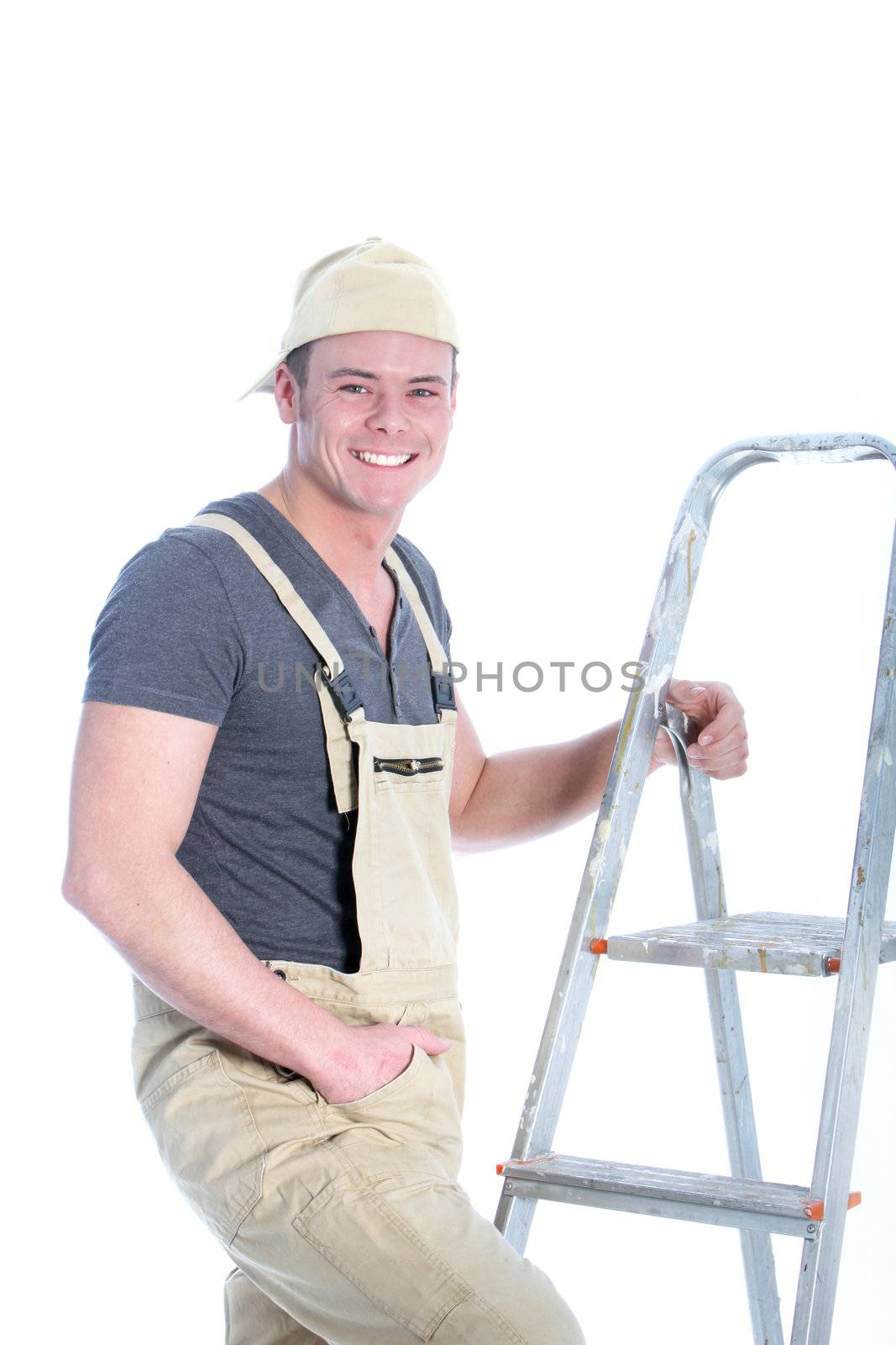 Smiling charismatic handyman with a lovely smile standing holding his ladder looking at the camera isolated on white