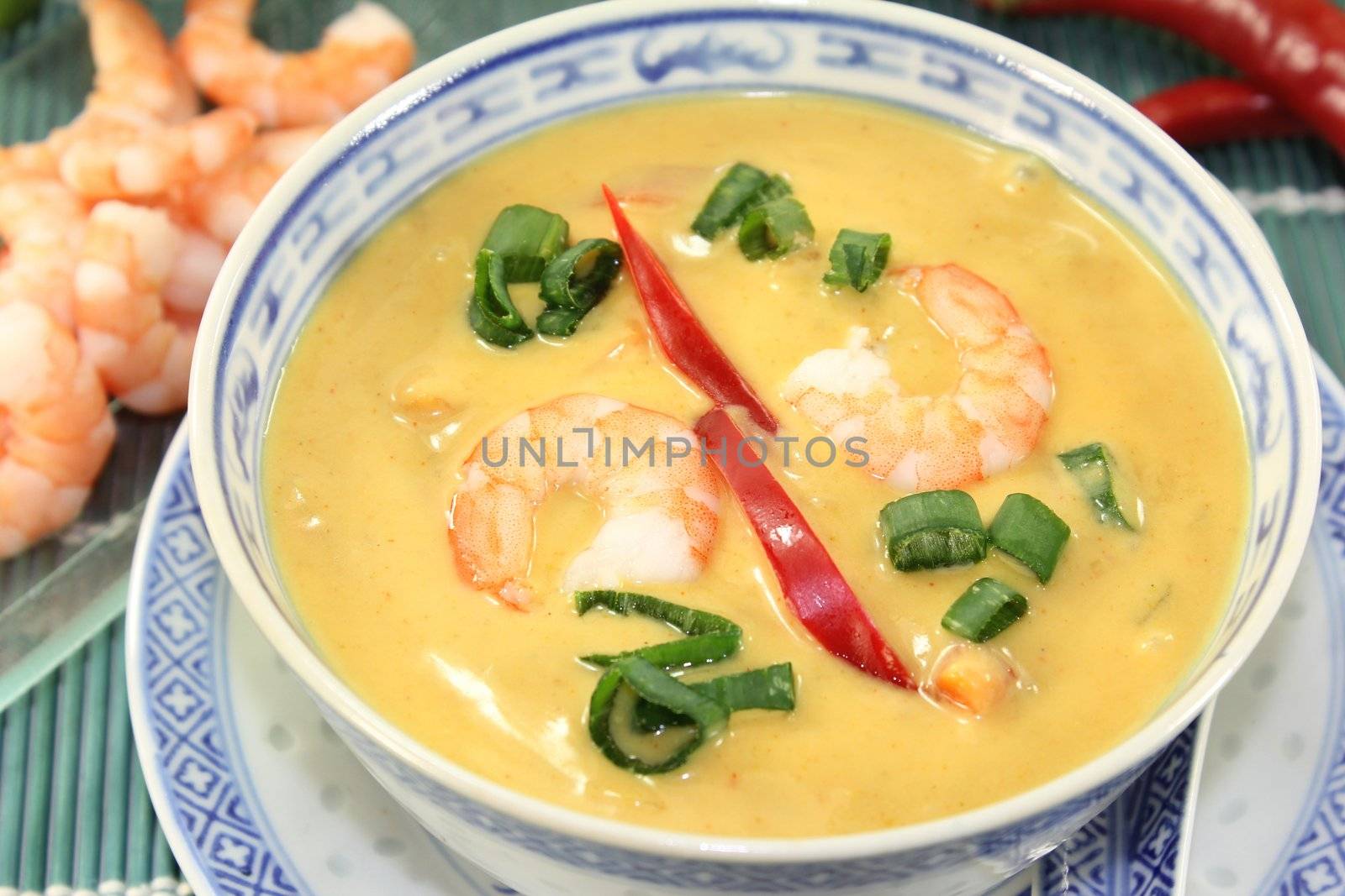 Curry soup with colorful vegetables and prawns