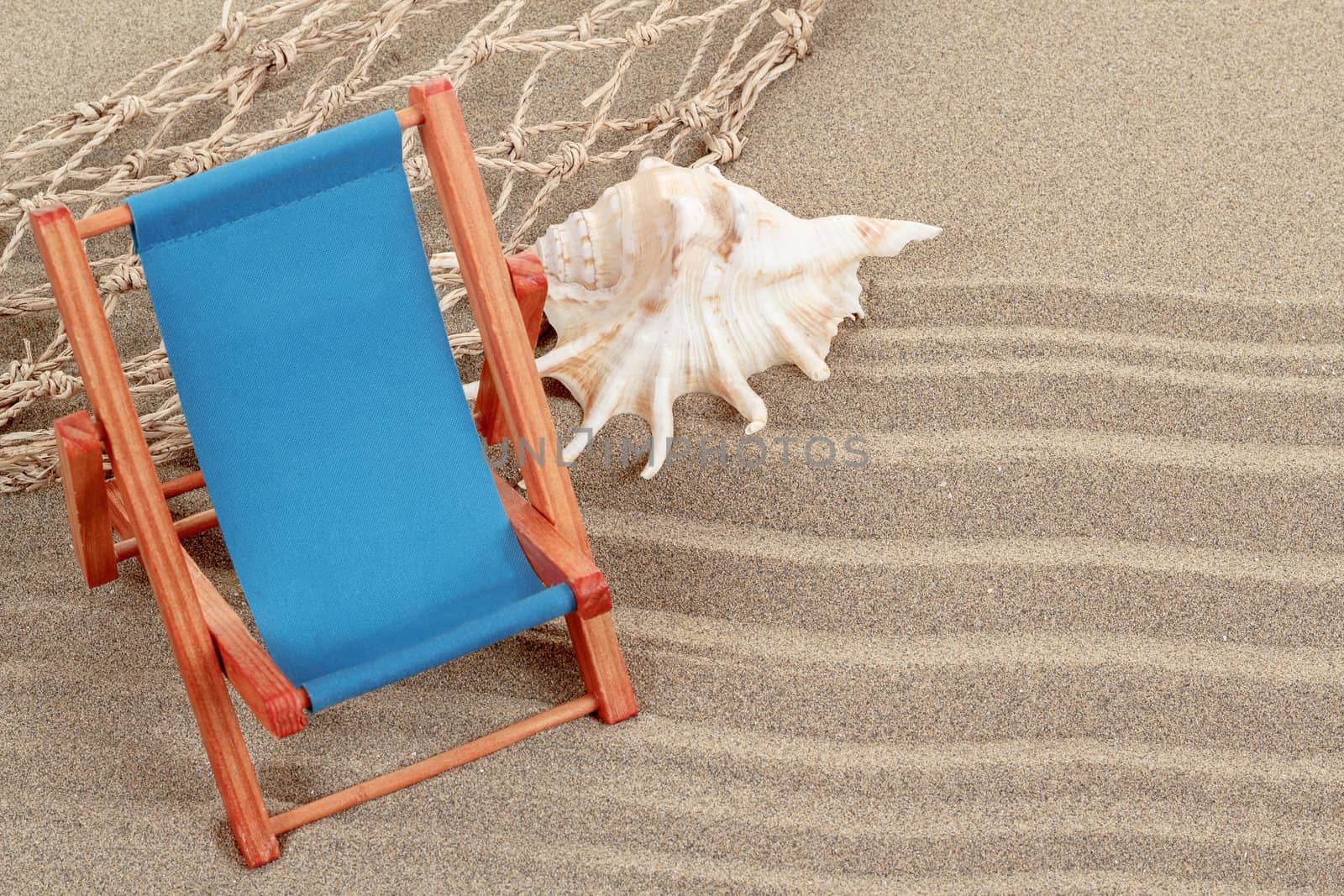 Still Life with seashell, and sun lounger in beach sand