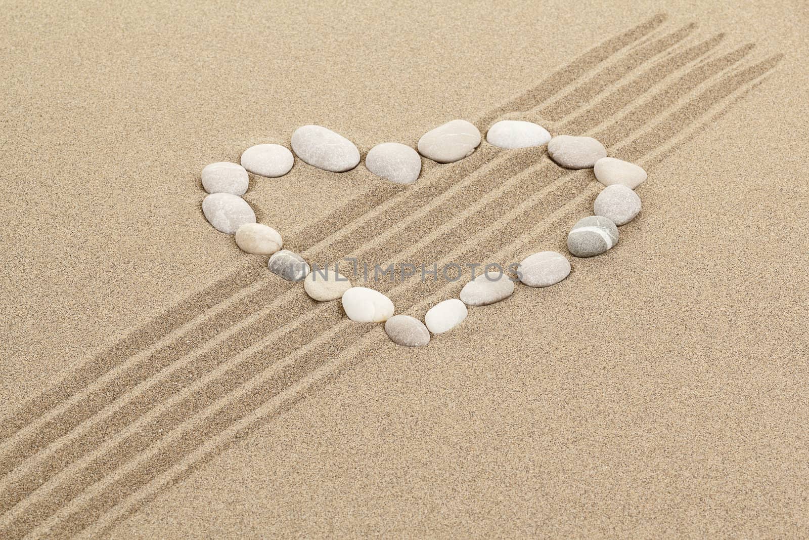 handwritten heart on yellow soft sand with seashell 