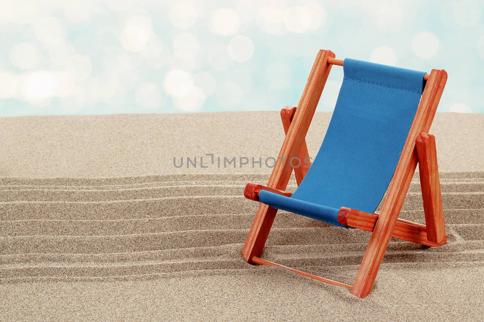 Vacation background with lounger in beach sand