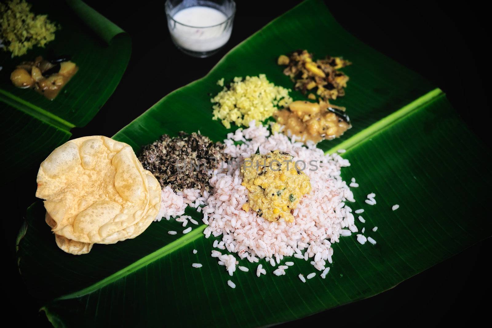 Indian breakfast is served on a sheet palm