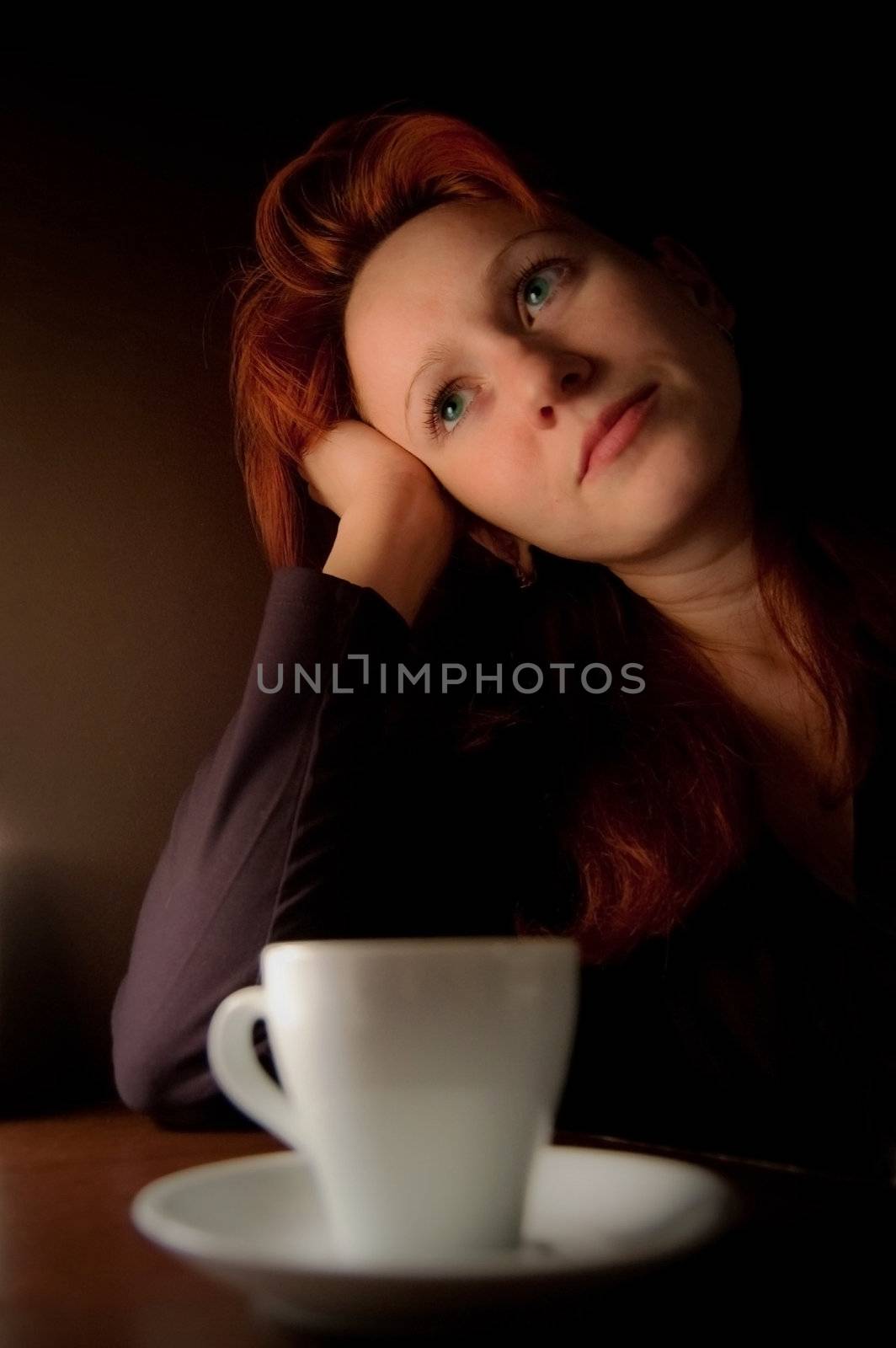 woman sitting at a table in a cafe