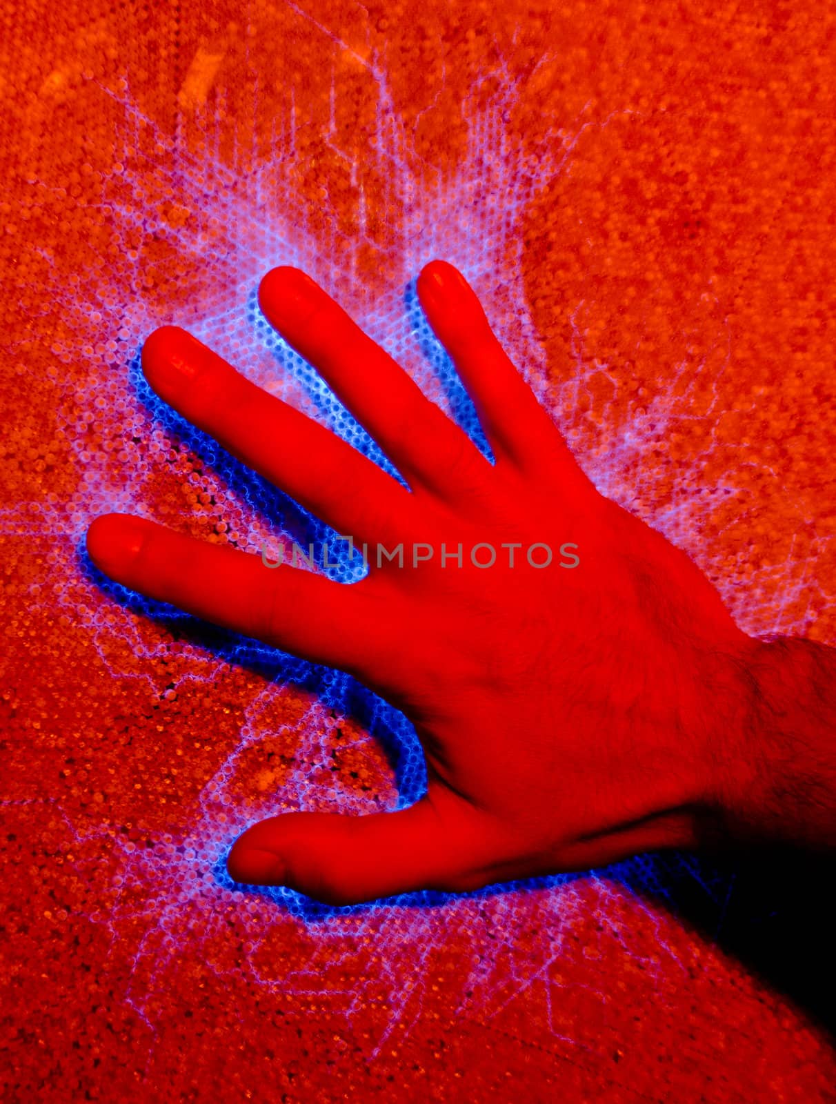 Hand on electricity charged surface creating blue sparks