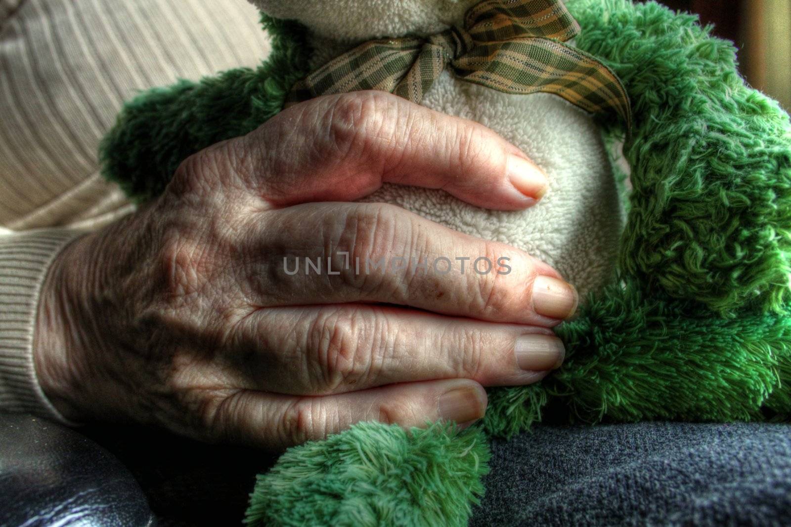 Elderly woman's hand holding a small doll