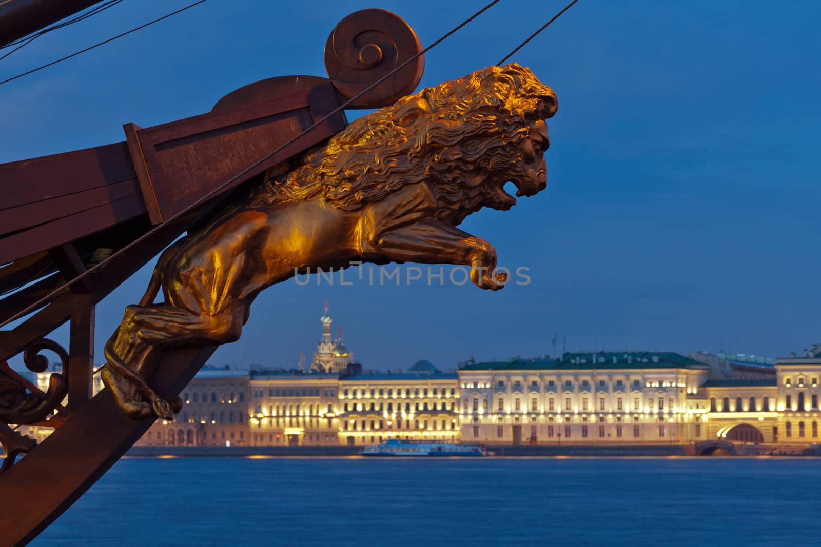 View of the Palace Embankment. In the foreground, a decorative sculpture of a lion on the bow of sailing ship. Twilight, white night. St. Petersburg. Russia