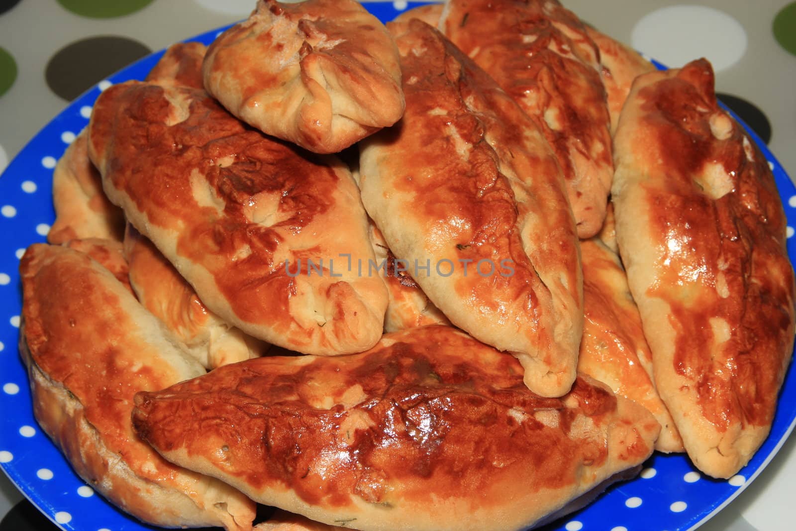 Roasted homemade pies stuffed with cabbage on a plate