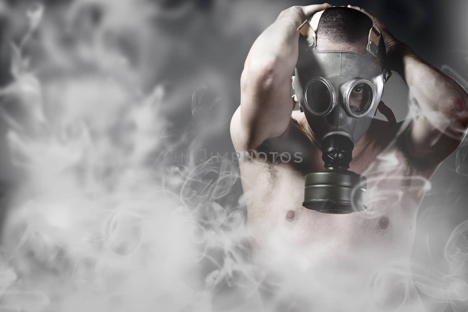 Portrait of a man in a polluted ambience with gas mask