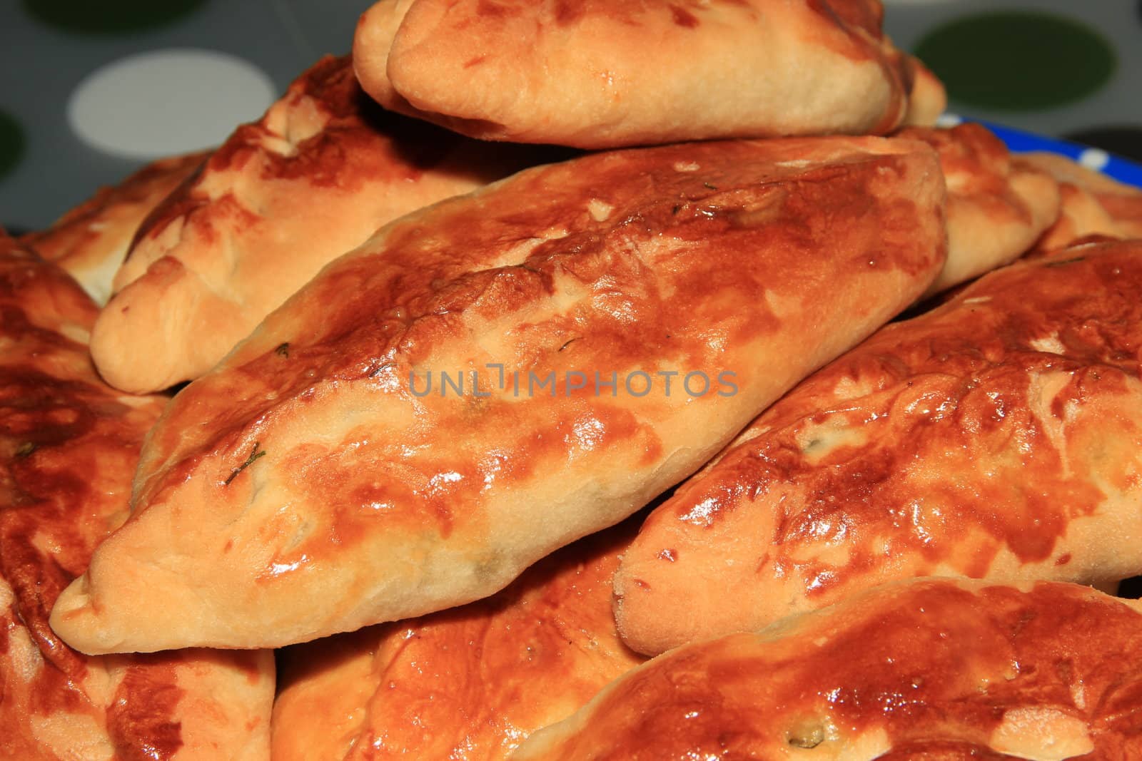 Roasted homemade pies stuffed with cabbage on a plate