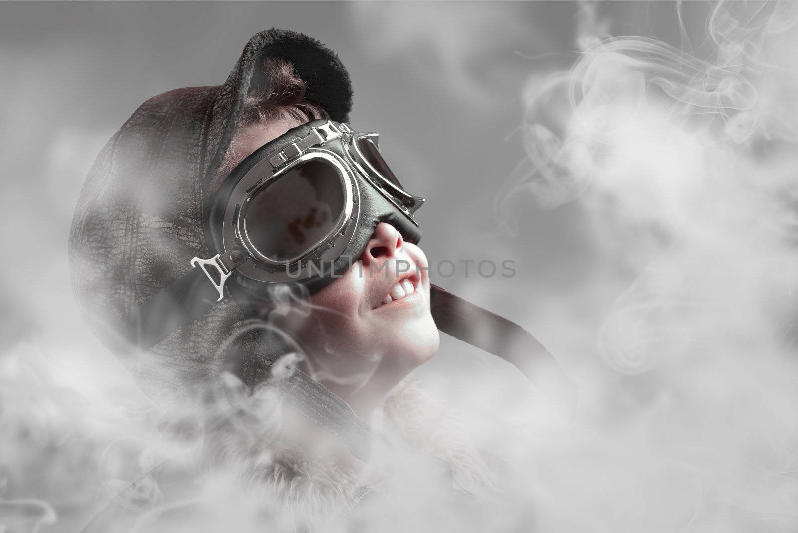Boy pilot smiling into smoke