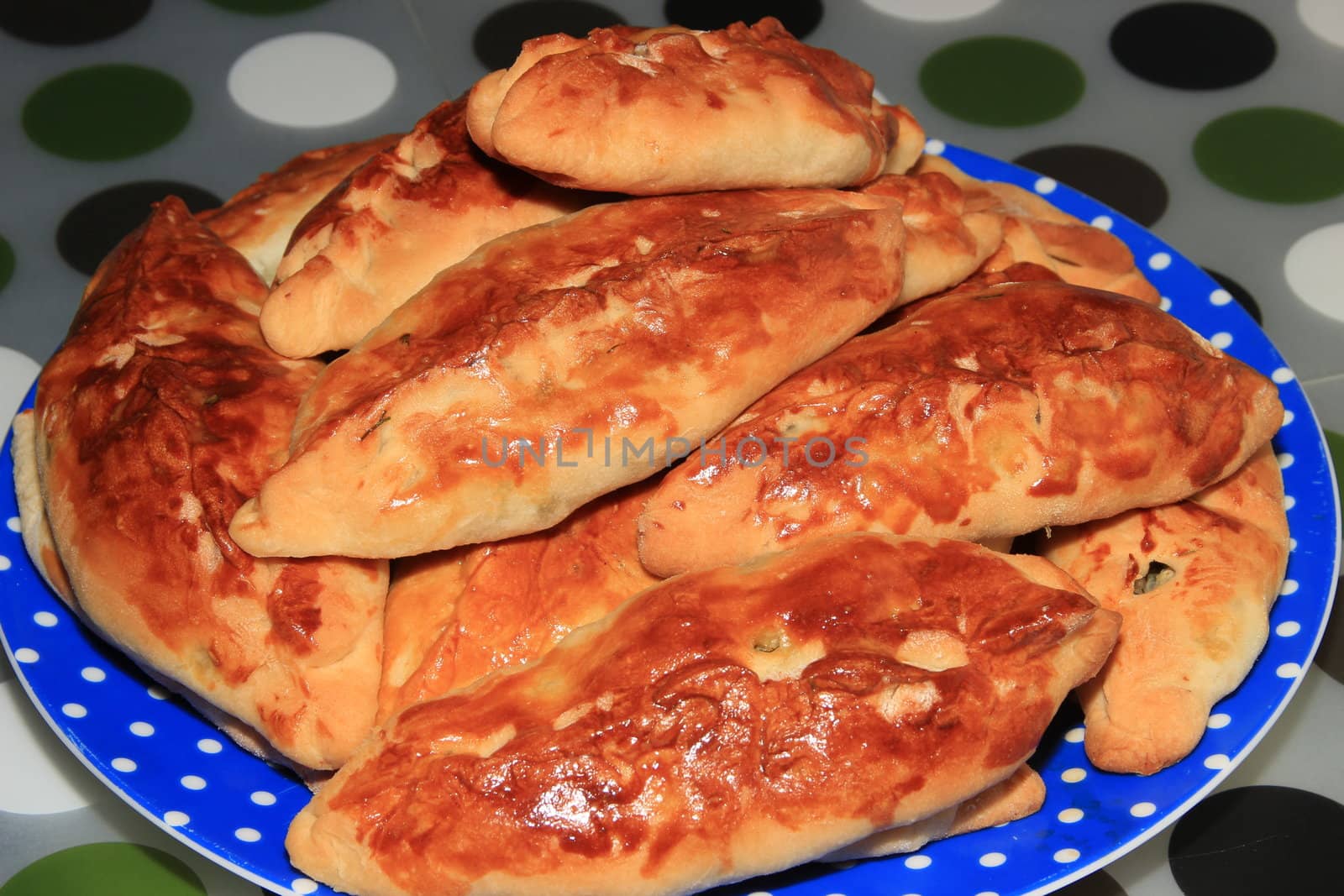 Roasted homemade pies stuffed with cabbage on a plate