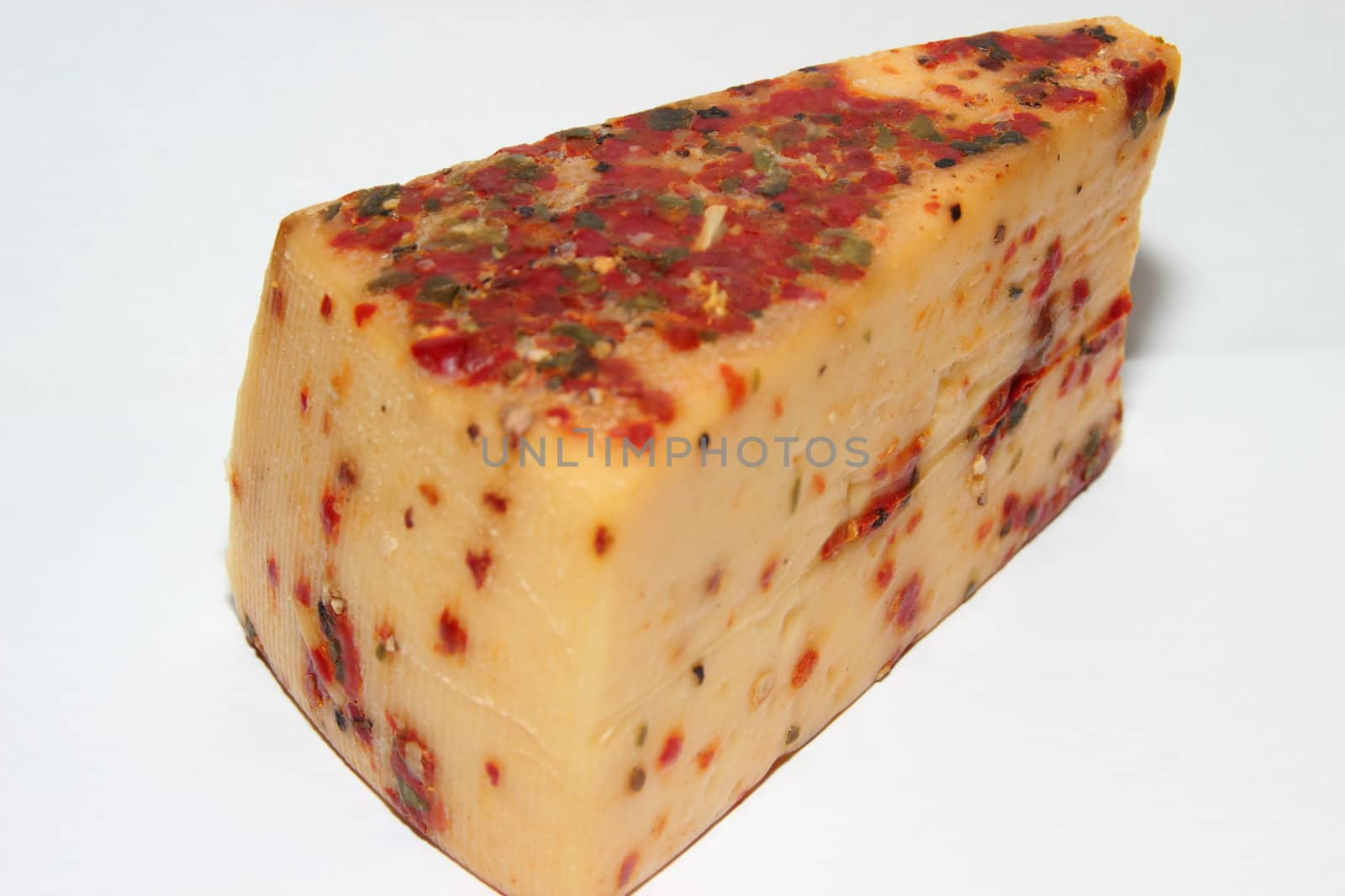 Piece of cheese with red bell pepper and spices