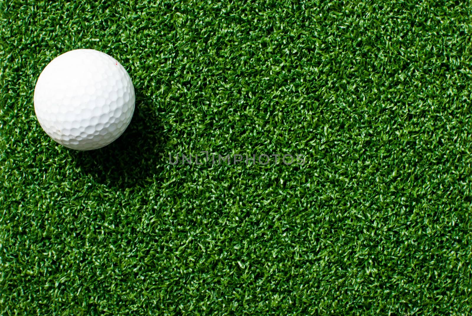 Golf ball on green grass by ponsulak