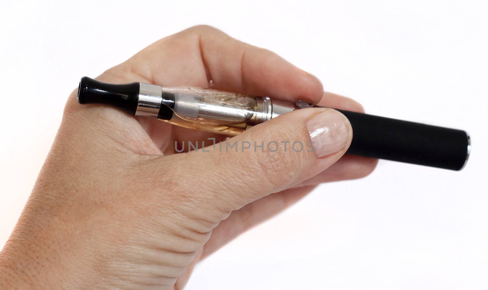 Close up of an electronic cigarette beihng held in hand. Isolated on white