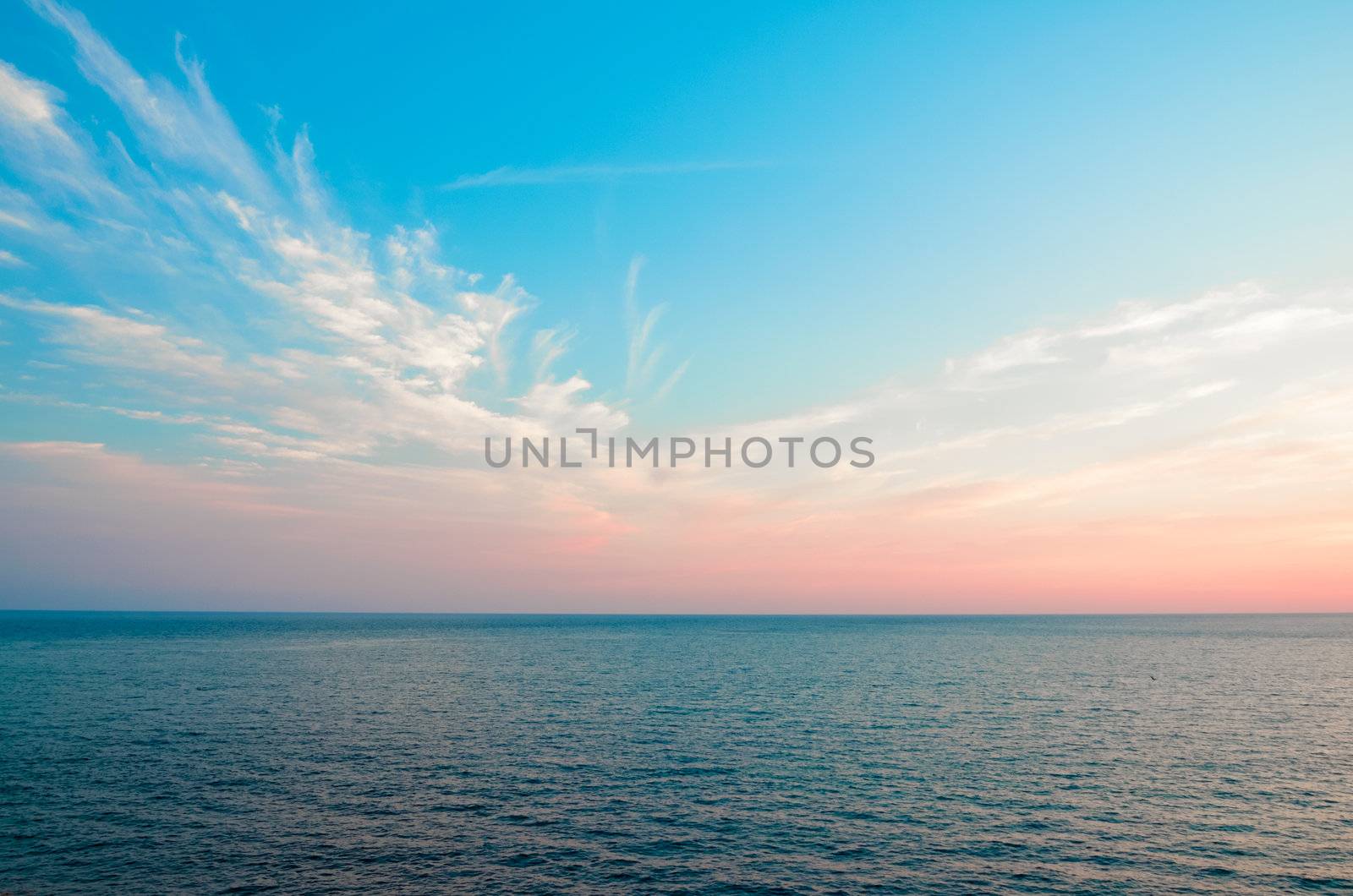 Blue sky with clouds in the background of the sea
