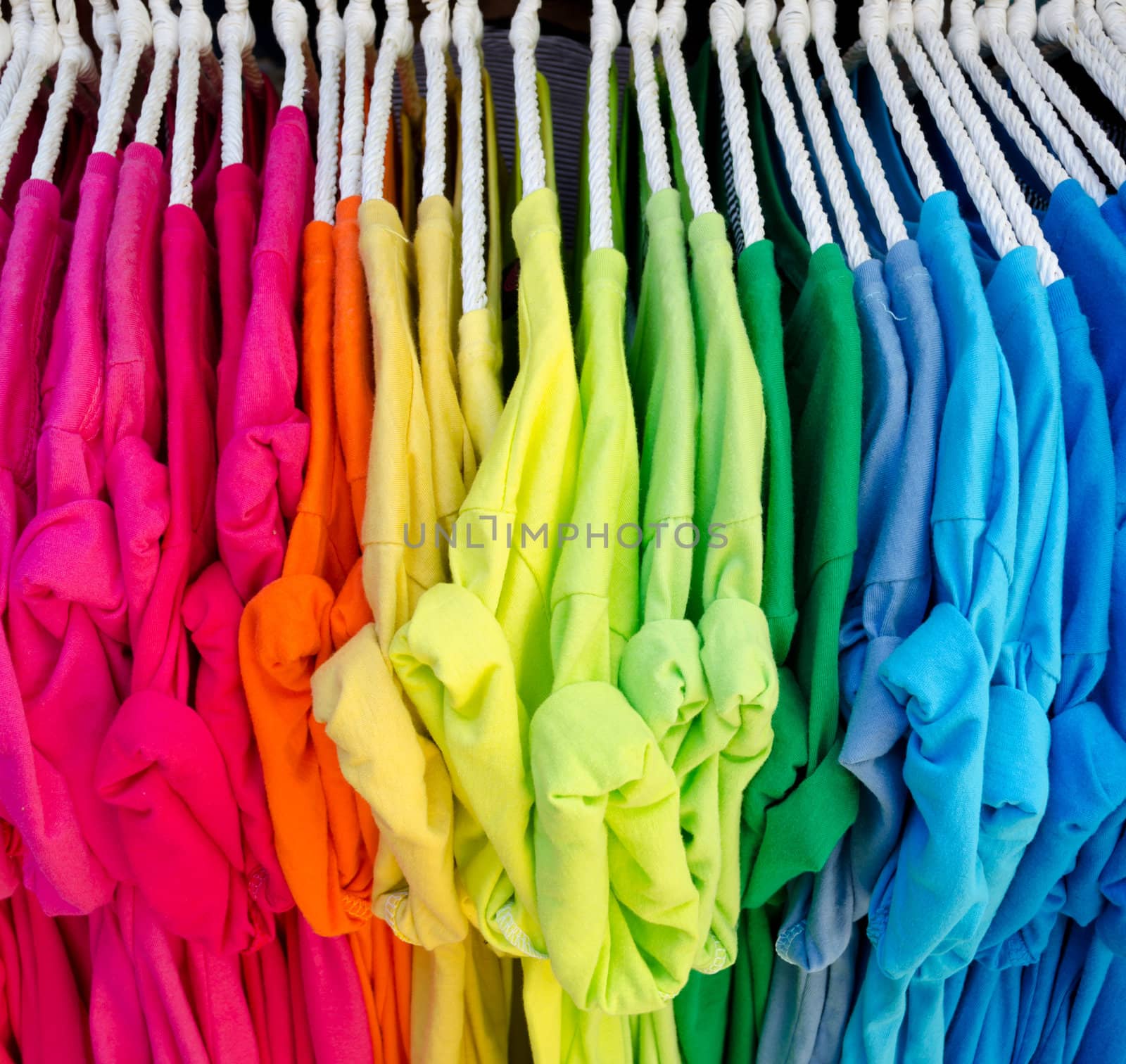 Colorful t-shirt on hangers