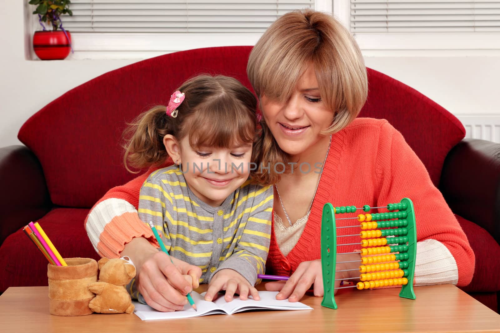 mother and daughter doing homework family scene
