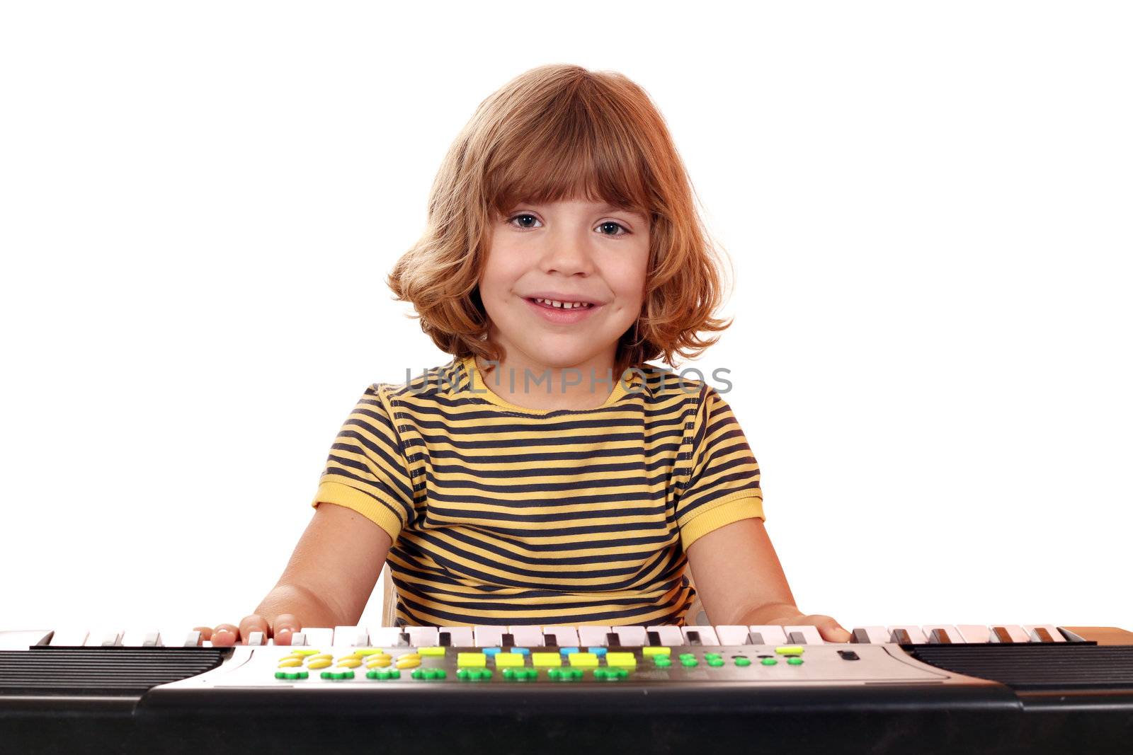 happy little girl play music on keyboard