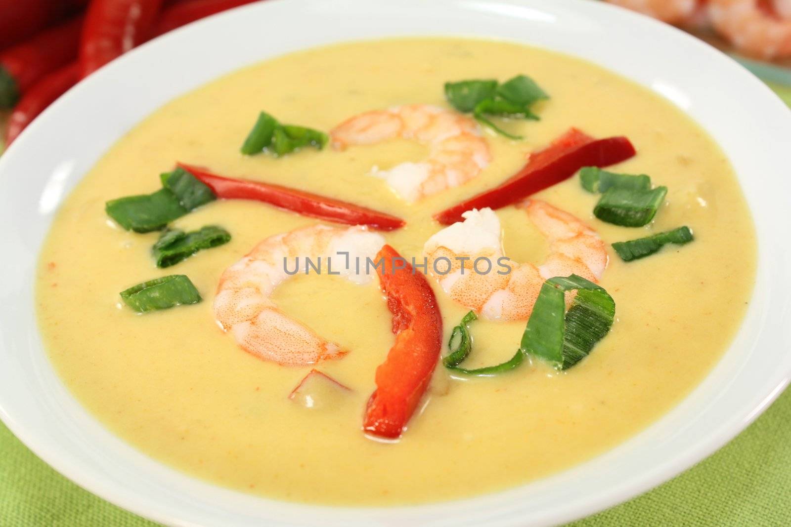 Curry soup with colorful vegetables and prawns