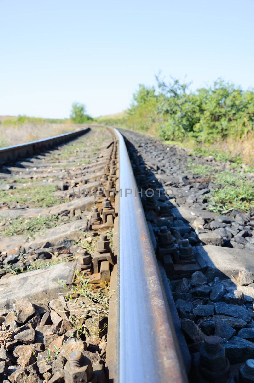 Railway track  cutting through rural countryside in summer