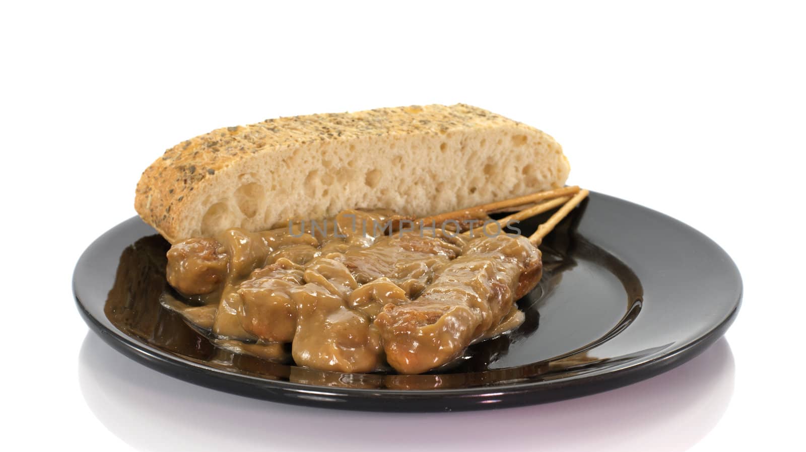asian dish with bread and sate on white background