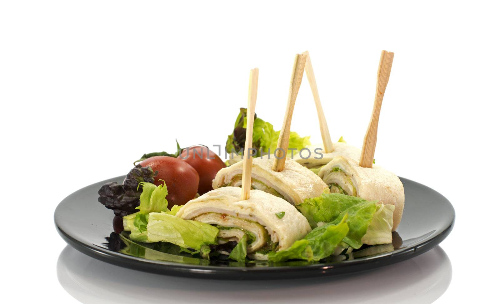 dish with salmon wraps salad and tomatoes