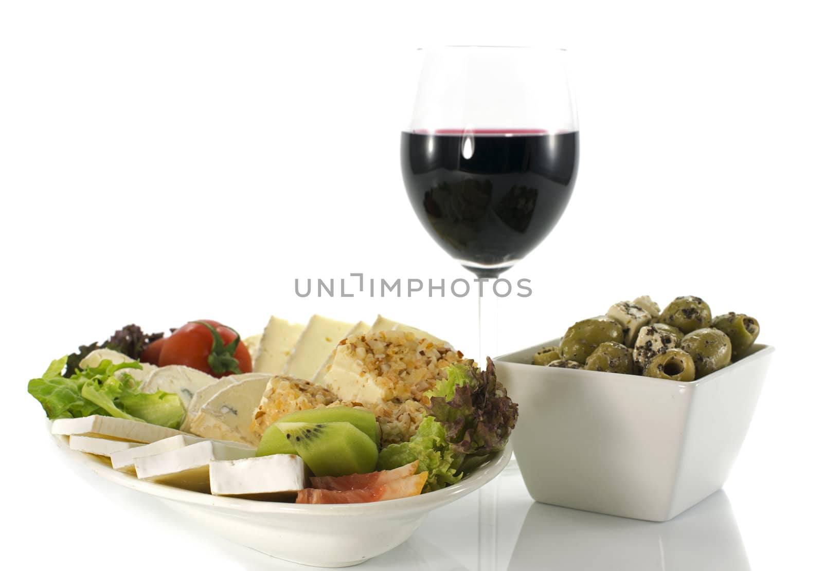 cheese plate with red wine and olives on white background