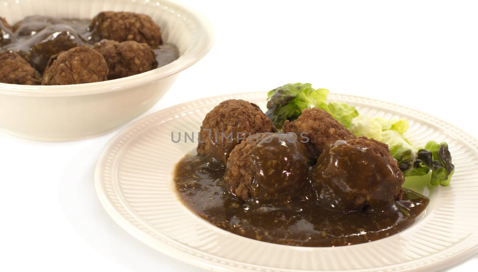 dish with meet balls on white background