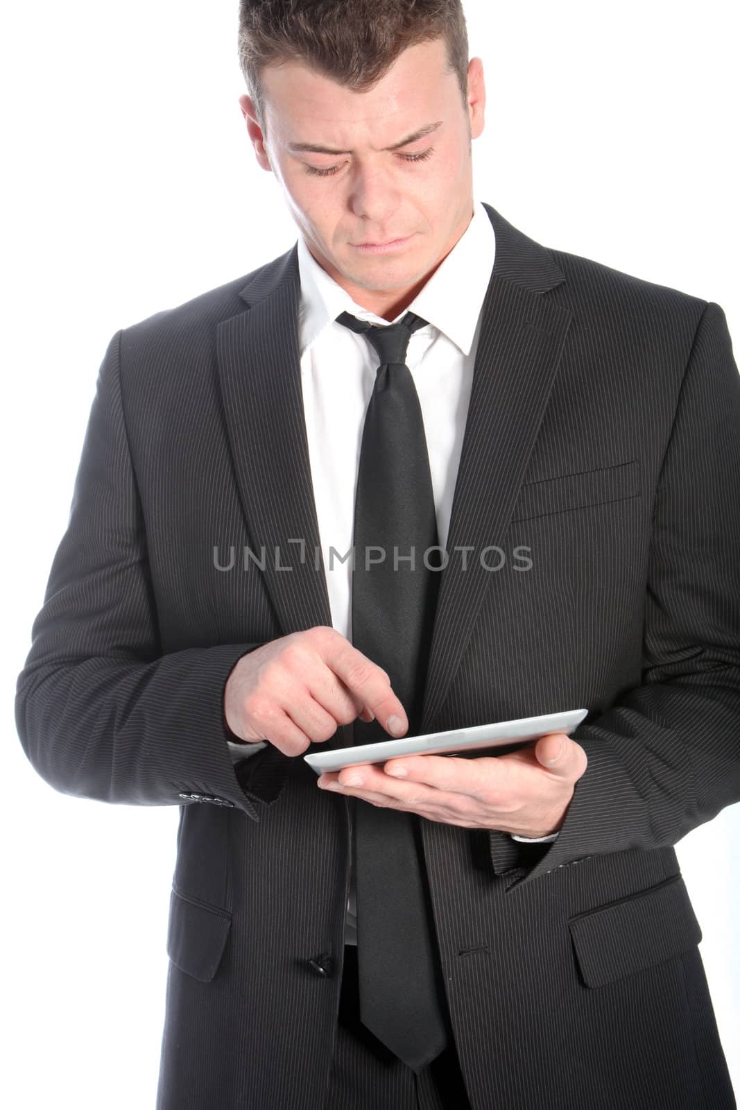 Serious businessman working on his tablet isolated on white