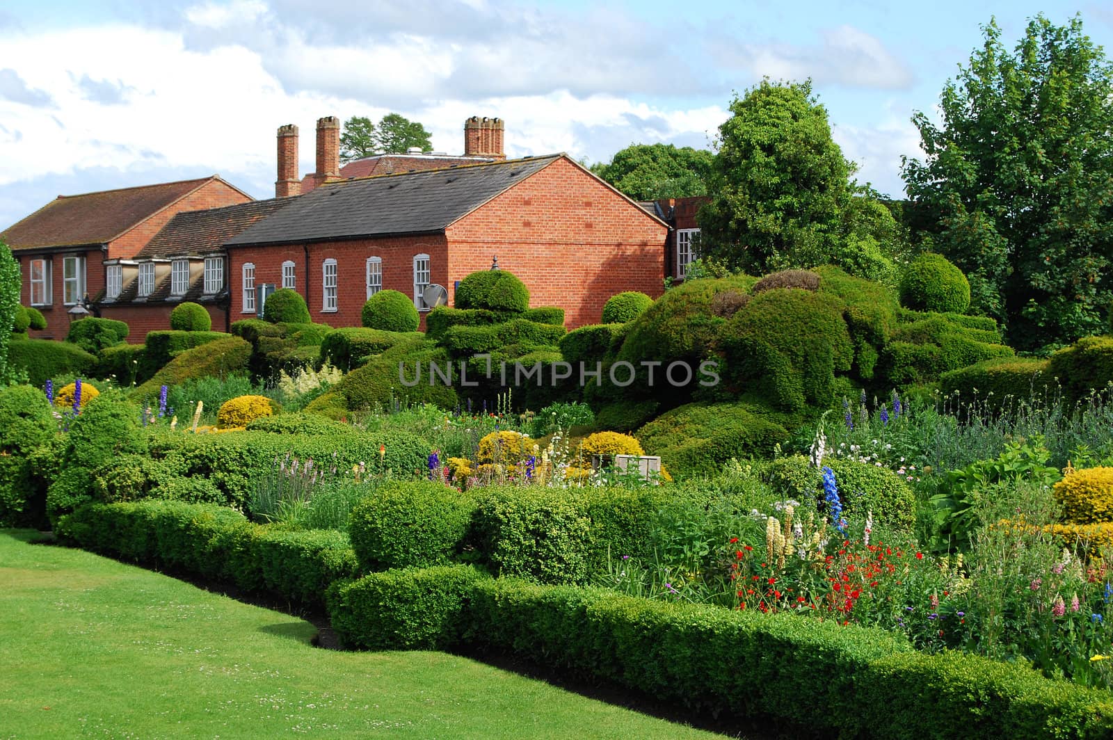 English garden and two old houses in summer