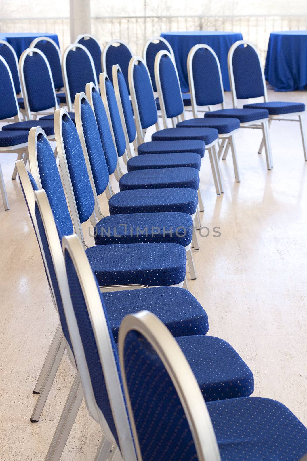 Curved row of empty conference chairs