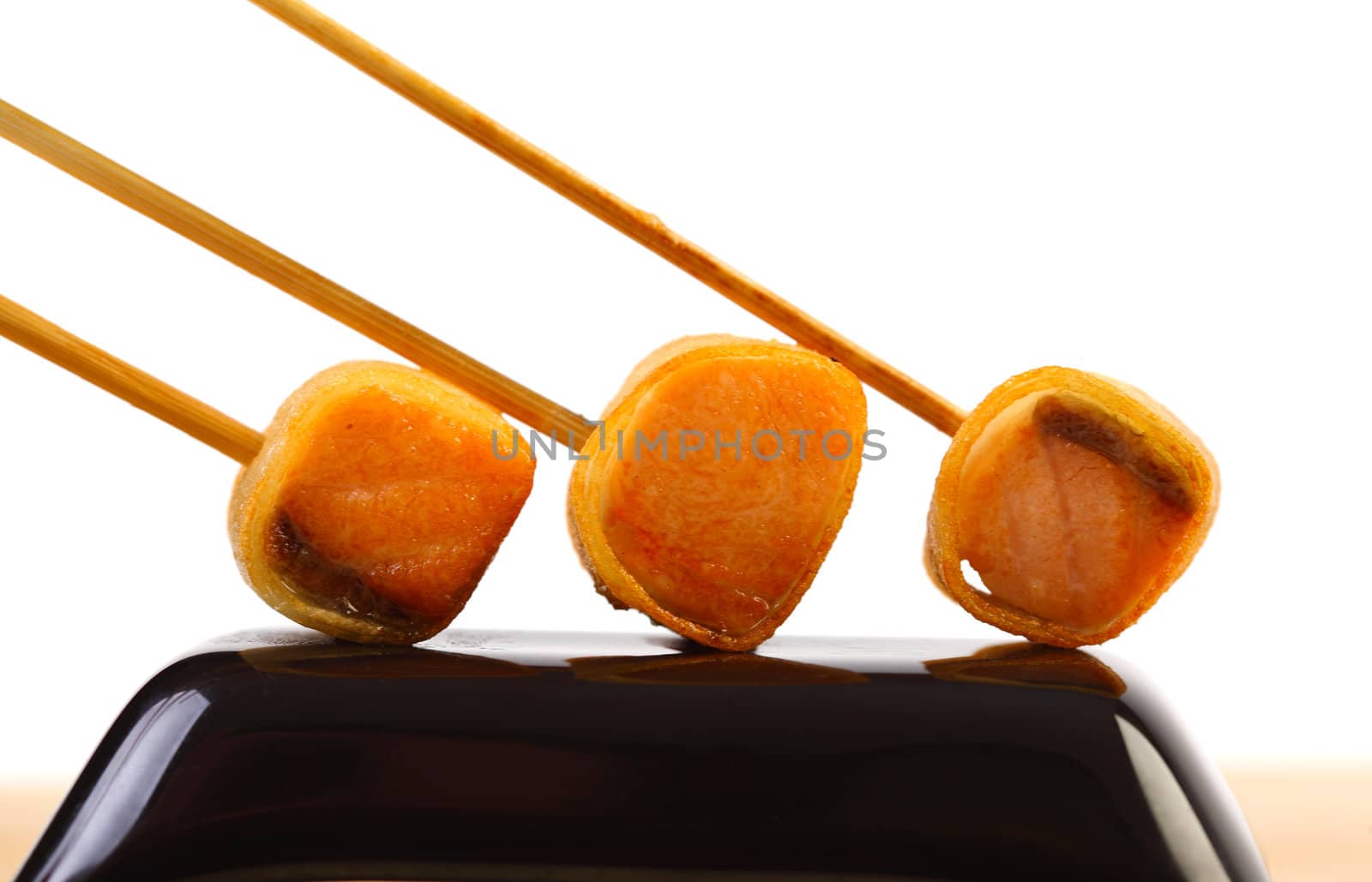 Salmon appetizers on stick on black plate