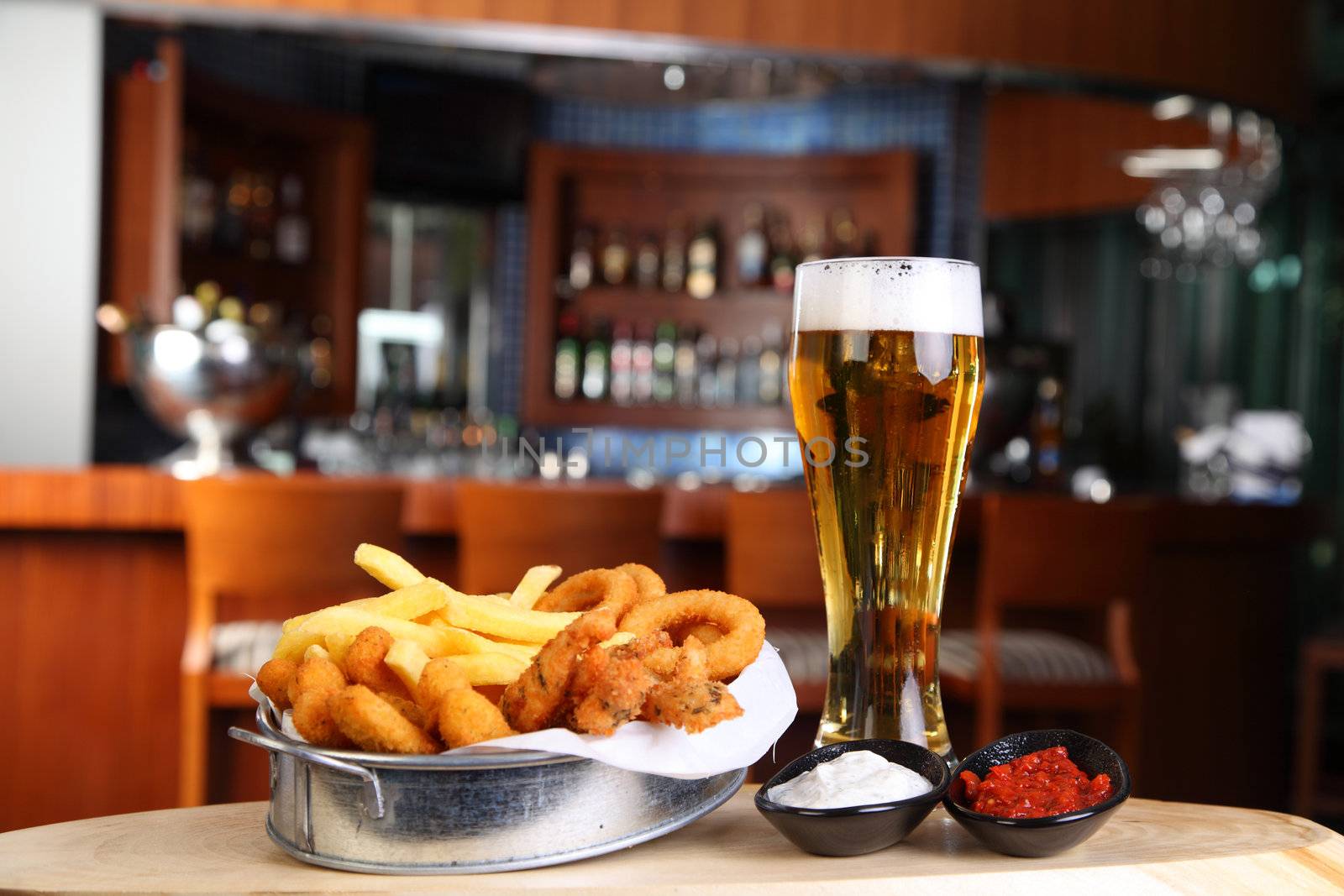 Fried calamar with a glass of beer in pub