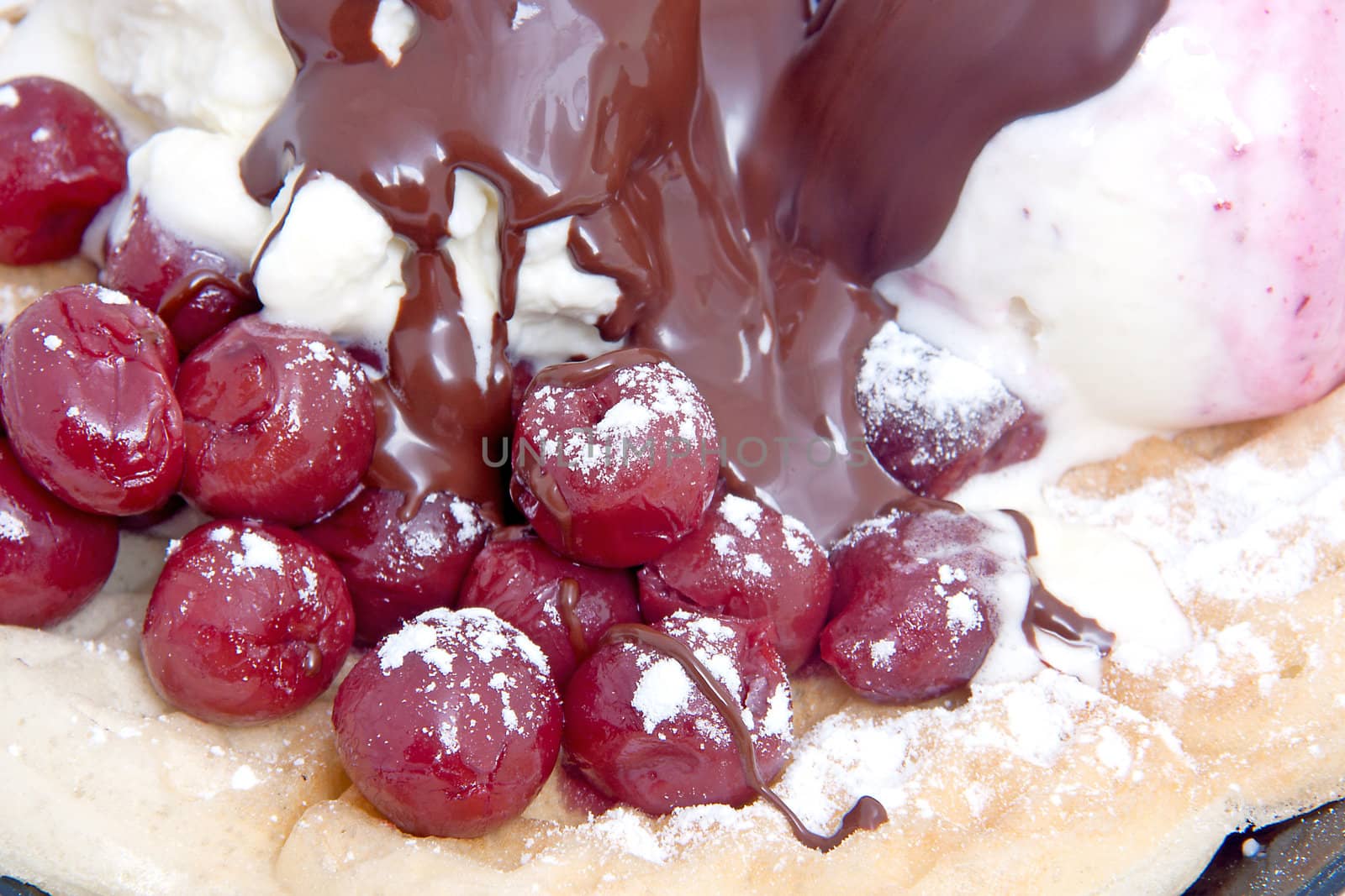 closeup of delicious dessert with  ice cream , chocolate sauce and cherries over white background