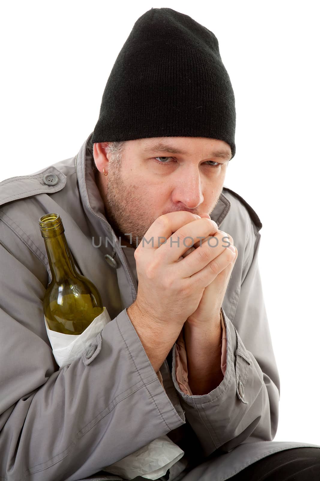 cold homeless tramp with empty bottle warming hand over white background