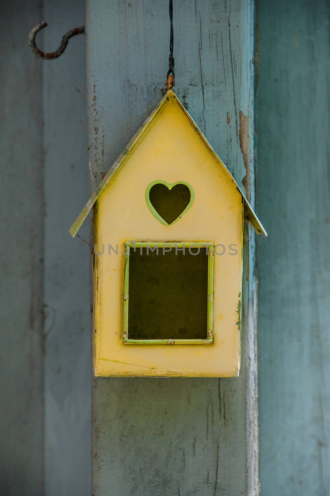 typical danish birdshouse on the blue wooden wall of a house