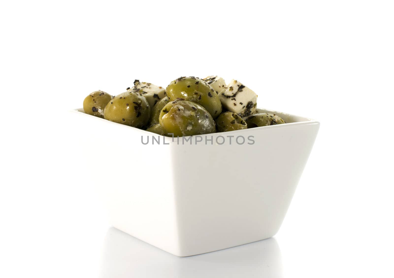 fetta cheese and green olives on white background