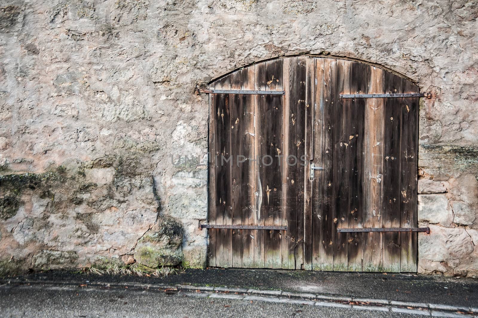 Old wooden door in a historical wall