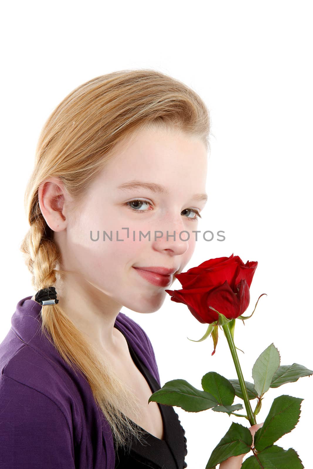 young girl smelling a red rose in closeup  by sannie32