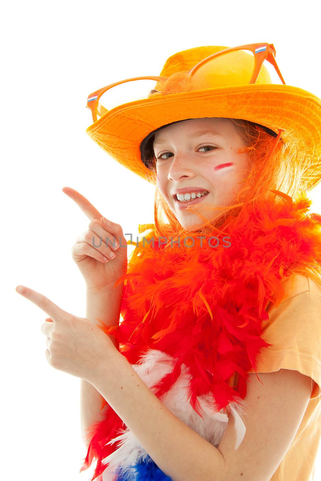 Dutch young girl dressed up as soccer supporter or queensday is pointing over white background