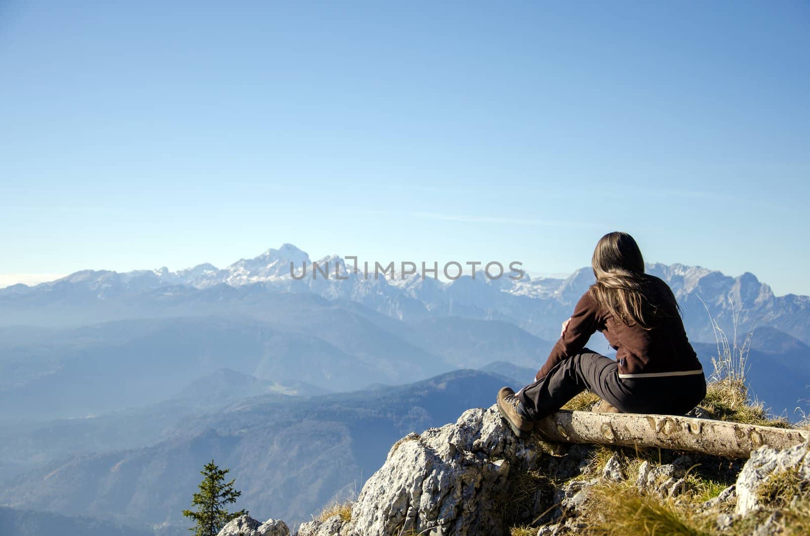 Young woman with a nice view over distant mountains.