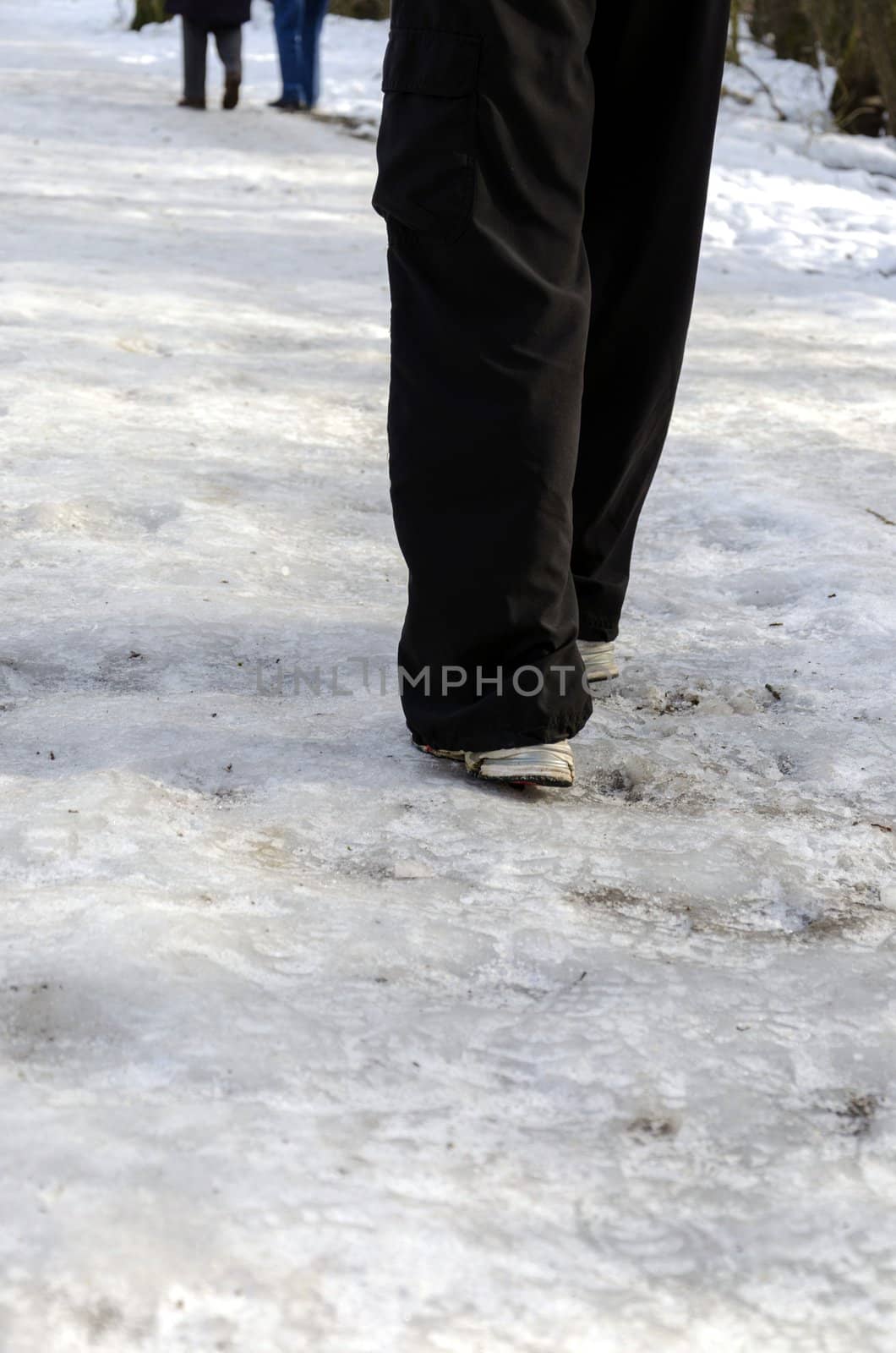 Slippery icy path through park in winter time.