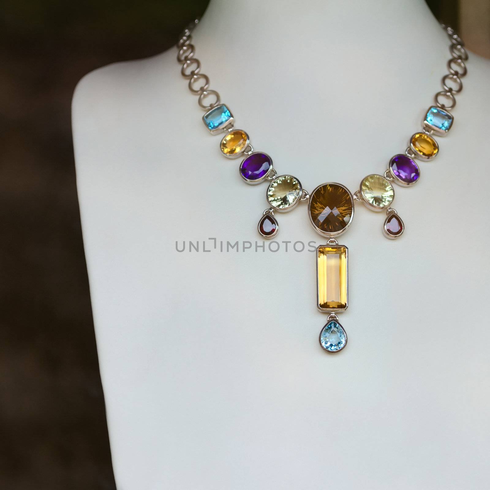 Necklace with many colored precious jewel (opals, sapphires), shallow depth of field