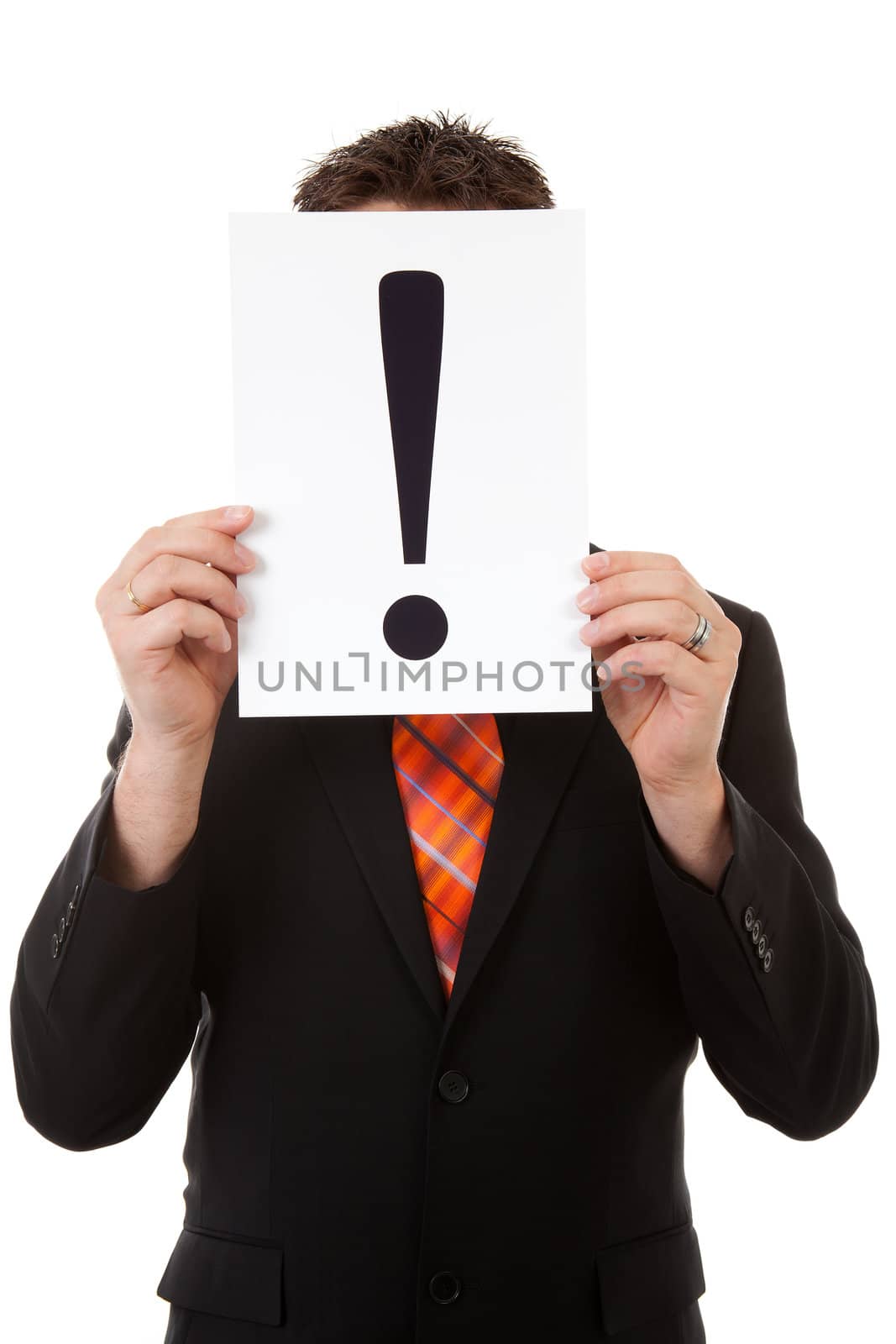 Businessman is holding a exclamation mark before face over white background