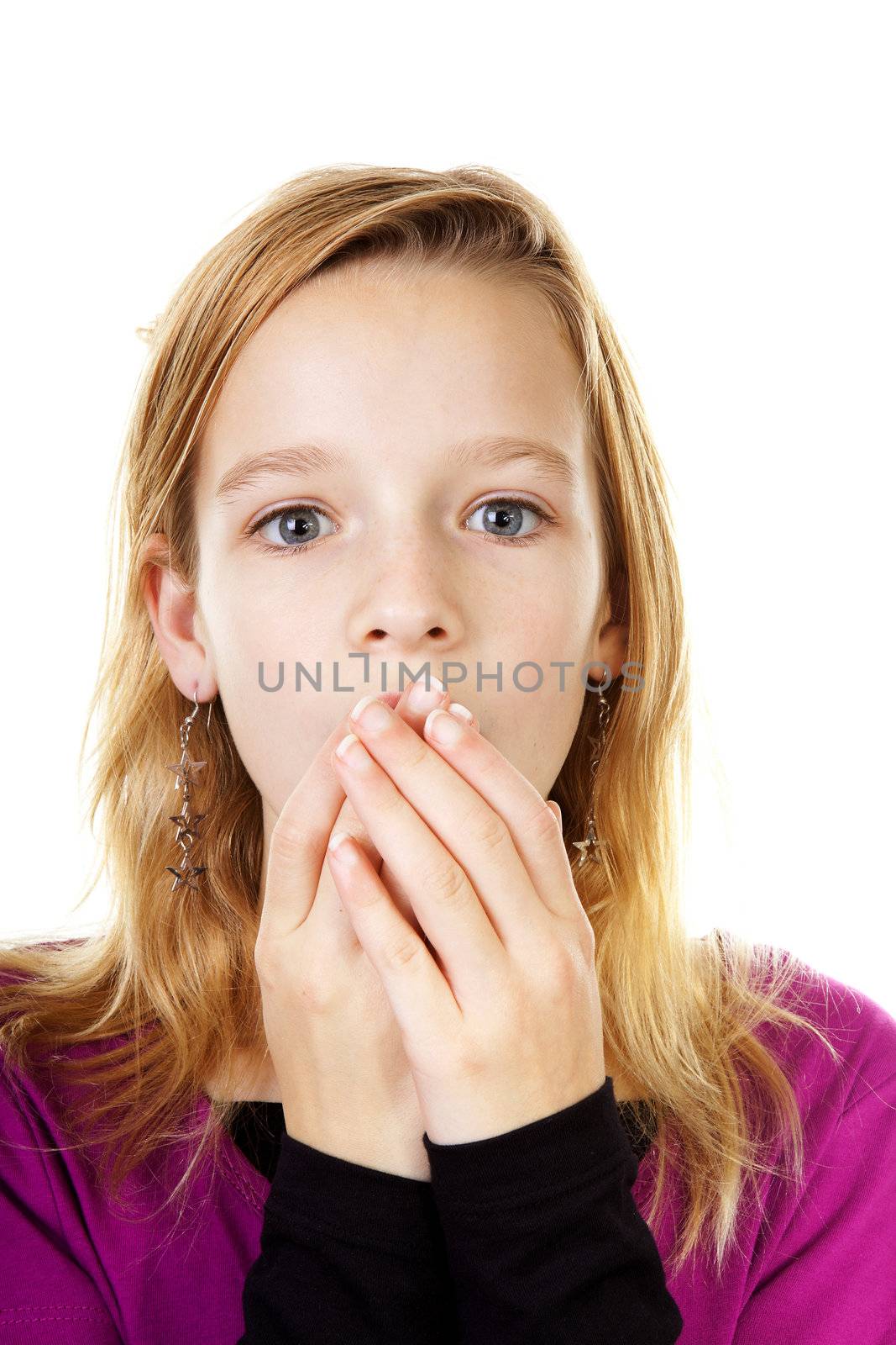 Girl looks surprised with hands to mouth over white background