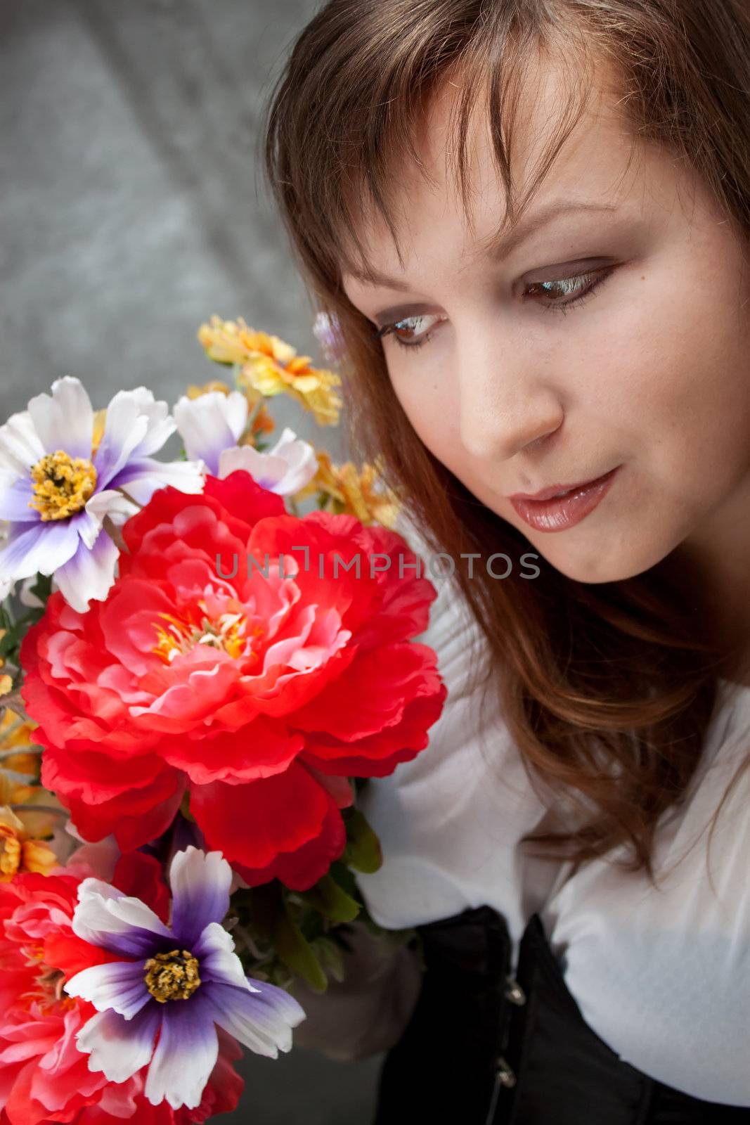 Portrait of a beautiful woman in medieval era dress with flowers