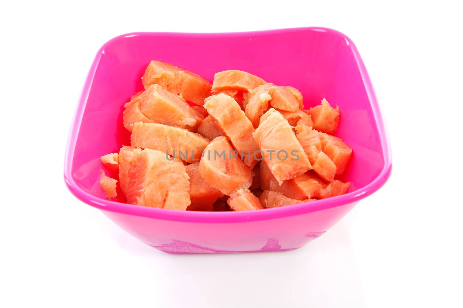 bowl with cubes raw salmon over white background