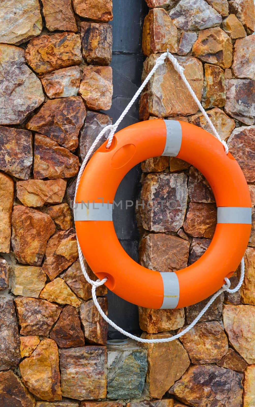 Lifebuoy with a rope hung on the wall