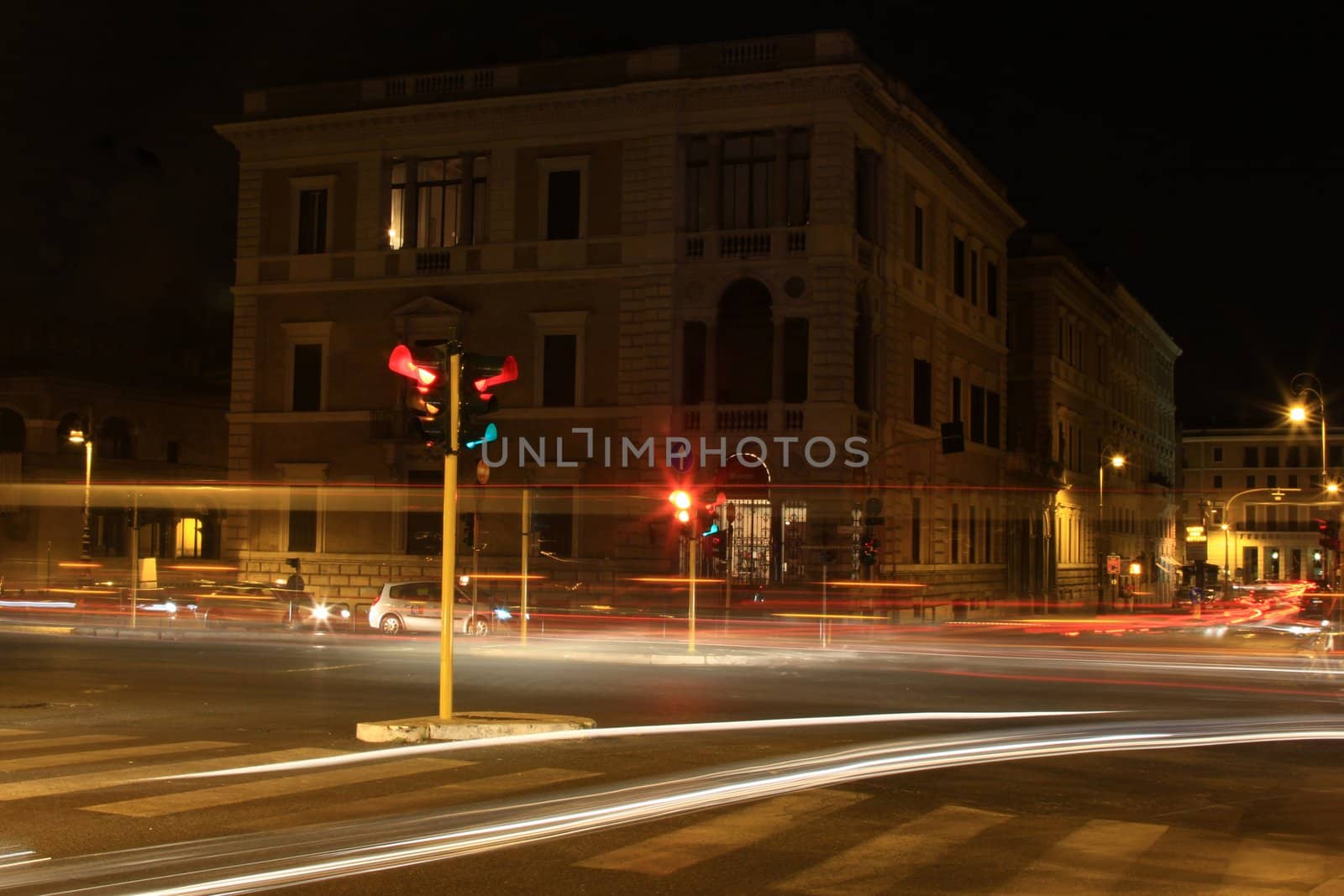 rome at night time with car light trail
