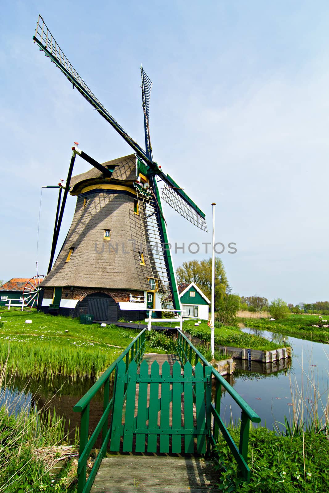 Landscape in Holland with windmills and a canal.